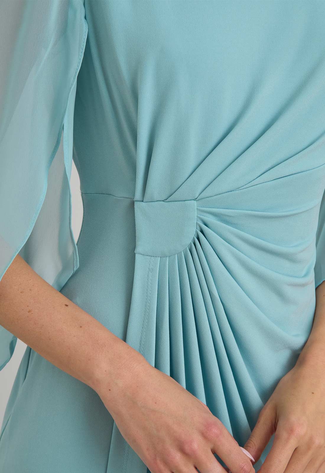 Light blue dress with a pleated design on a white background