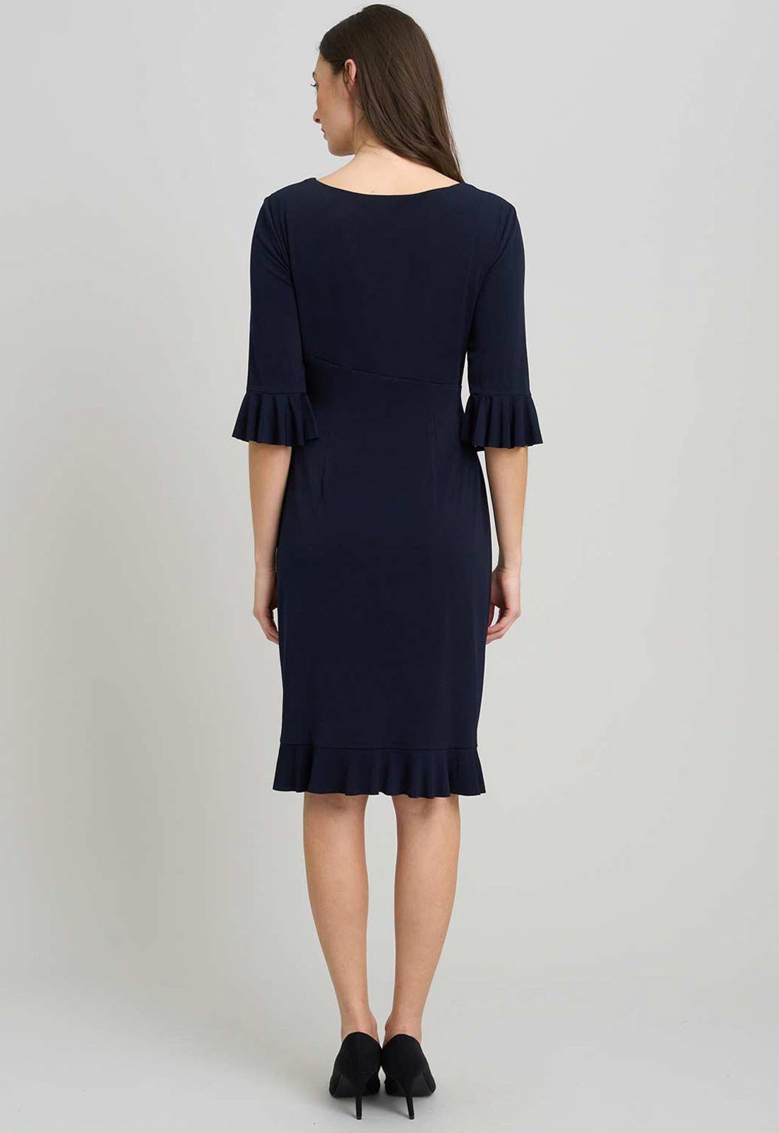 Navy blue dress with ruffled sleeves and hem on a gray background