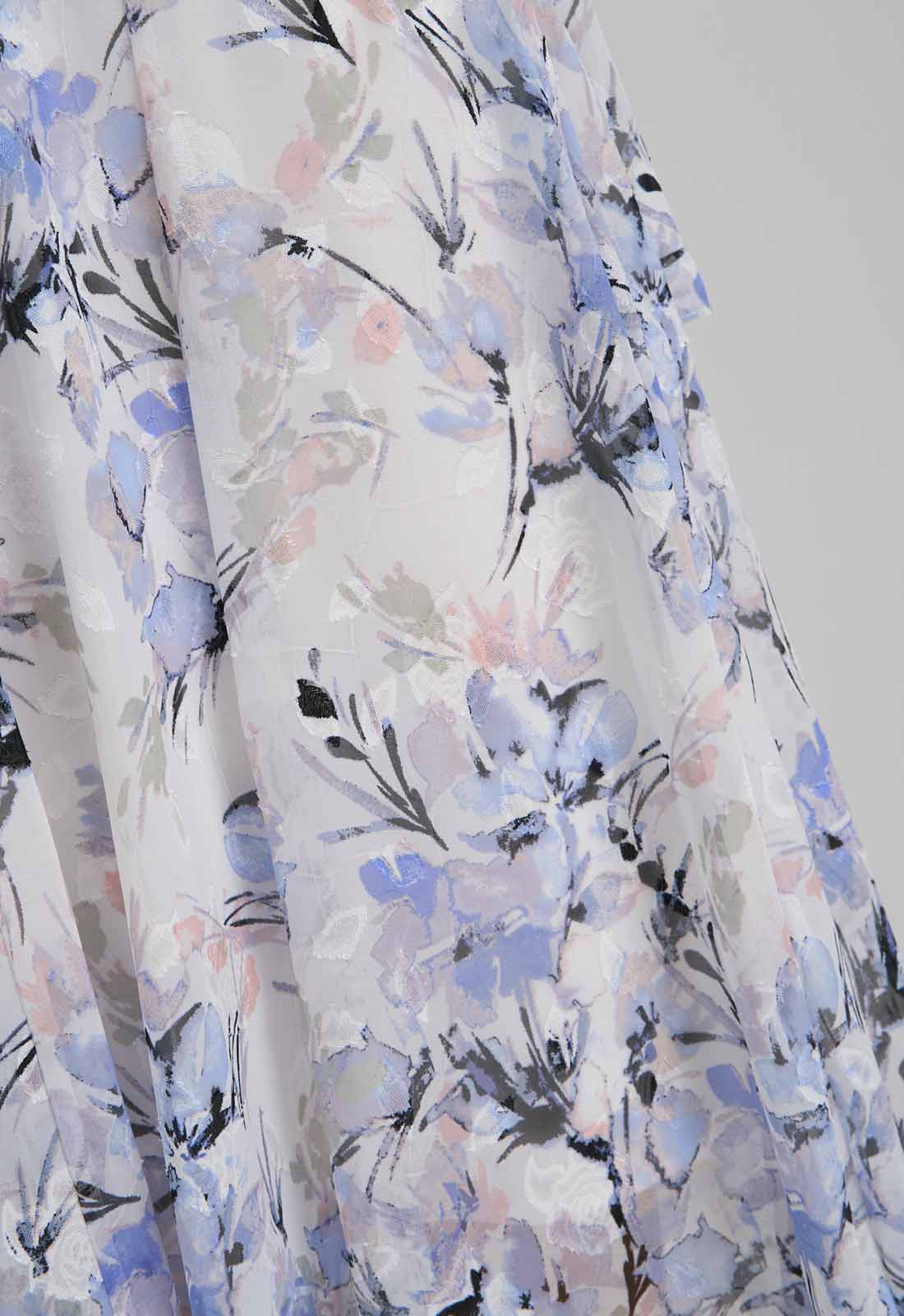 Floral patterned fabric with blue, black, and pink colors on a white background