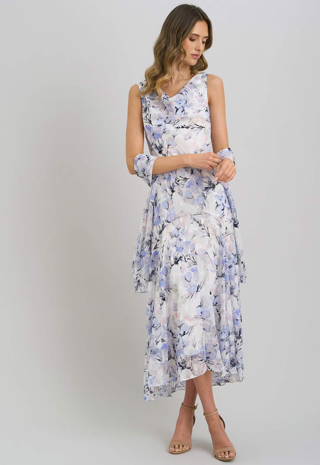 Woman wearing a floral dress on a plain background
