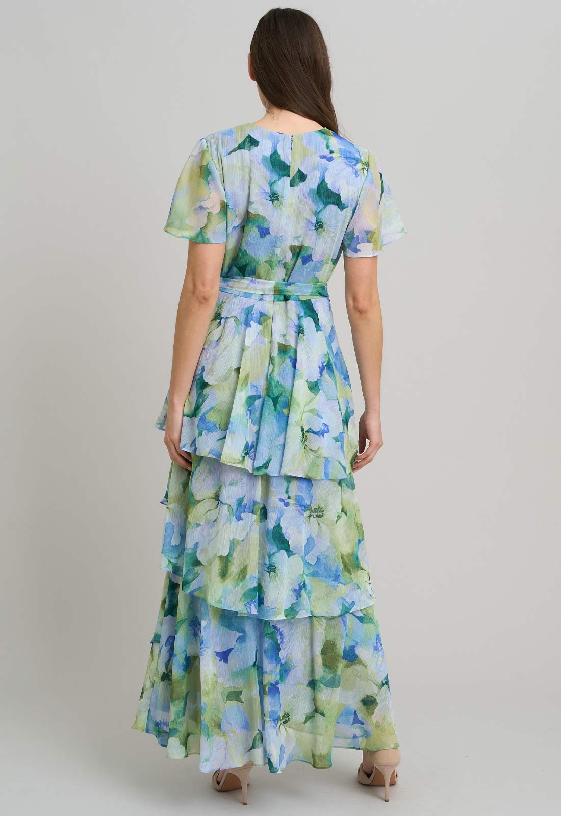Woman wearing a floral dress with a plain background