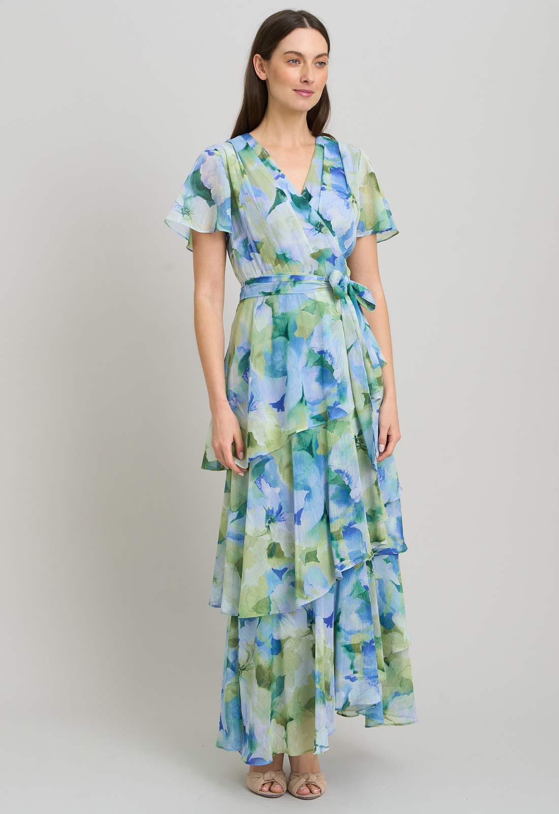 Woman wearing a floral dress on a plain background
