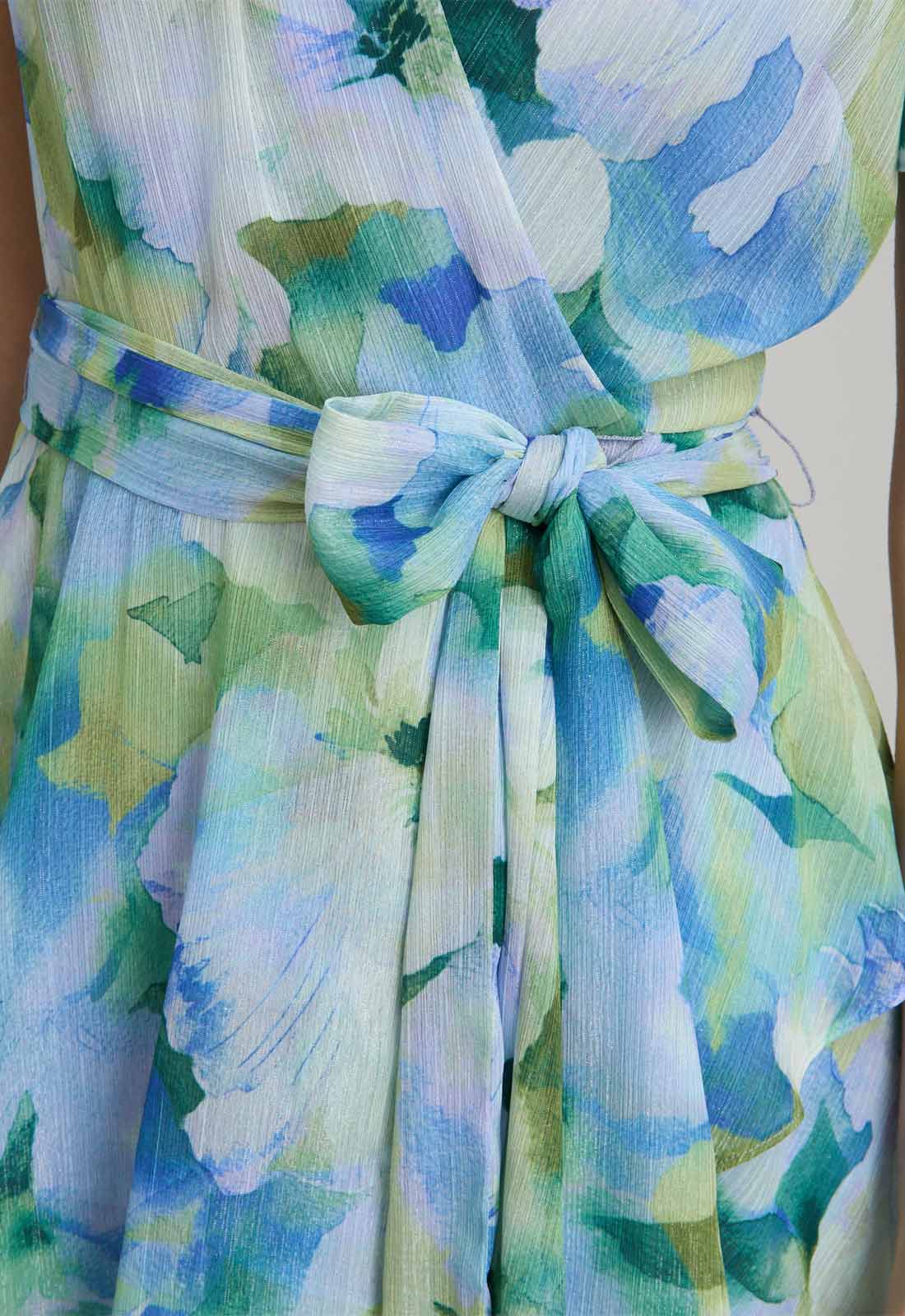 Floral patterned dress with a belt and bow detail.