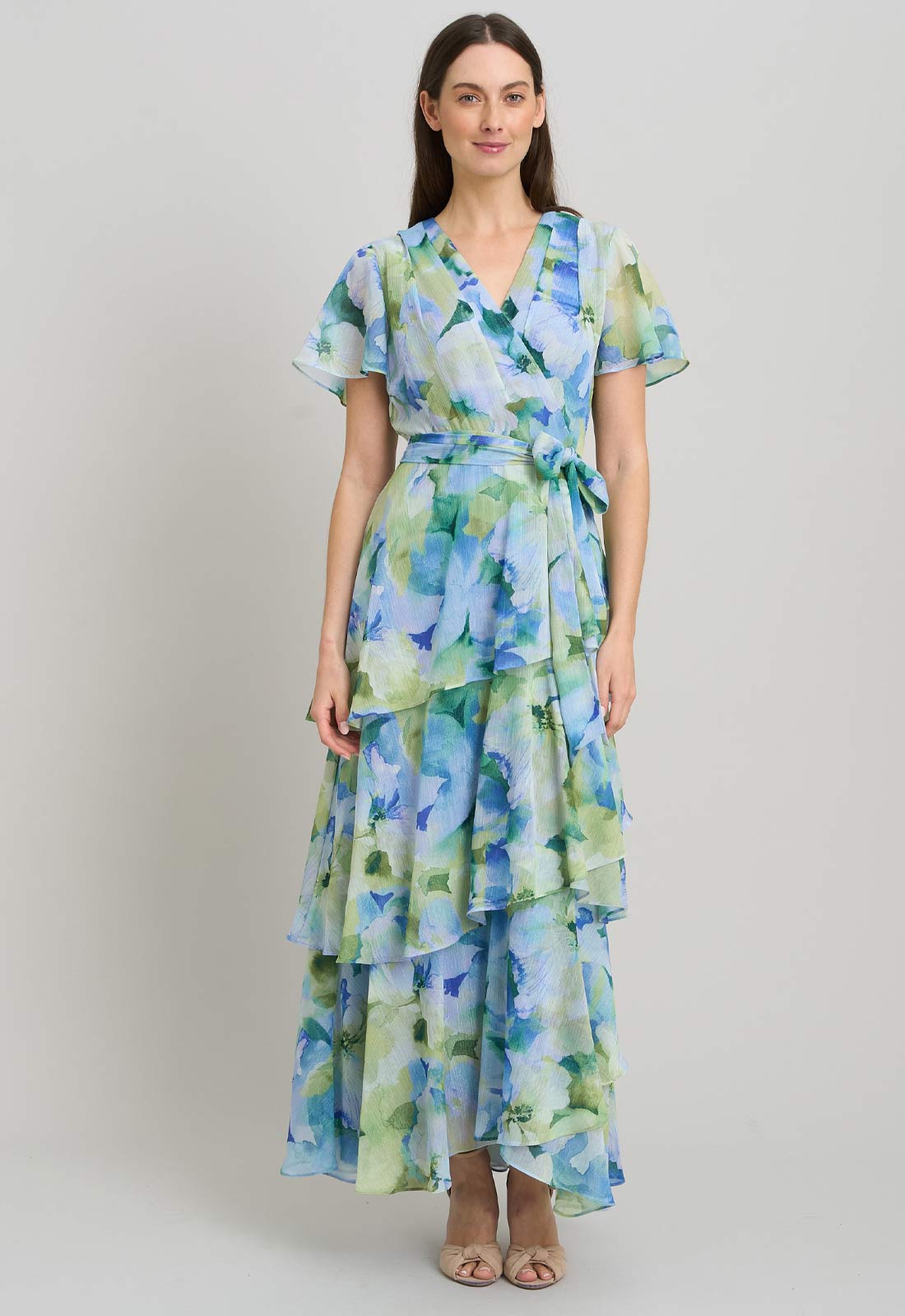Woman wearing a floral dress on a plain background