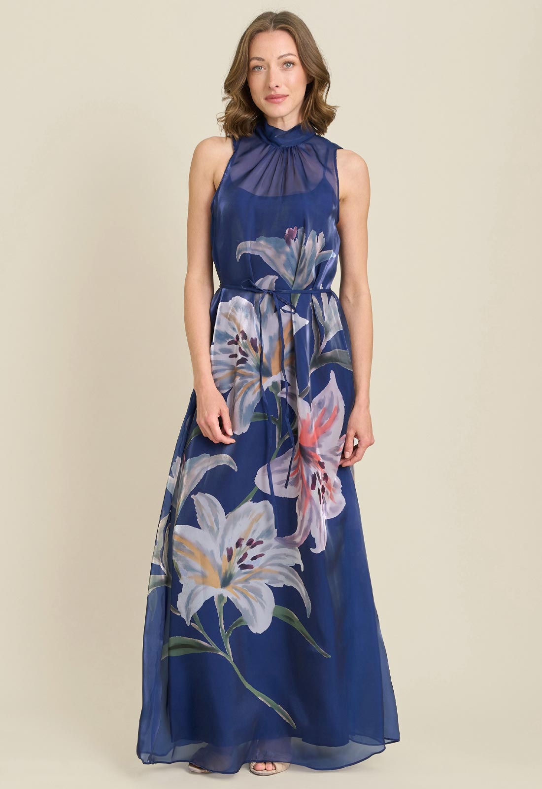 Woman wearing a blue floral dress on a beige background