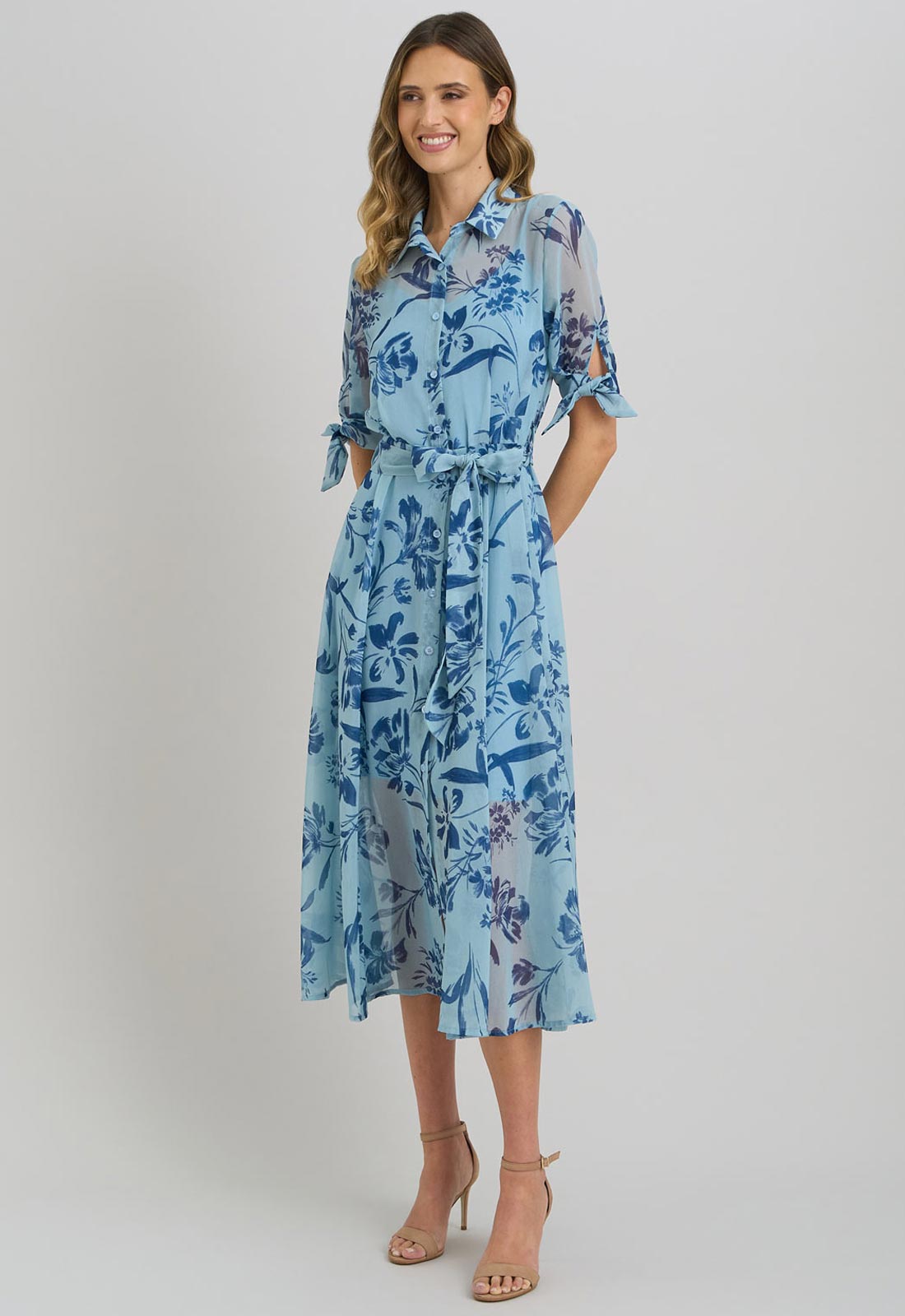Woman wearing a blue floral dress on a white background