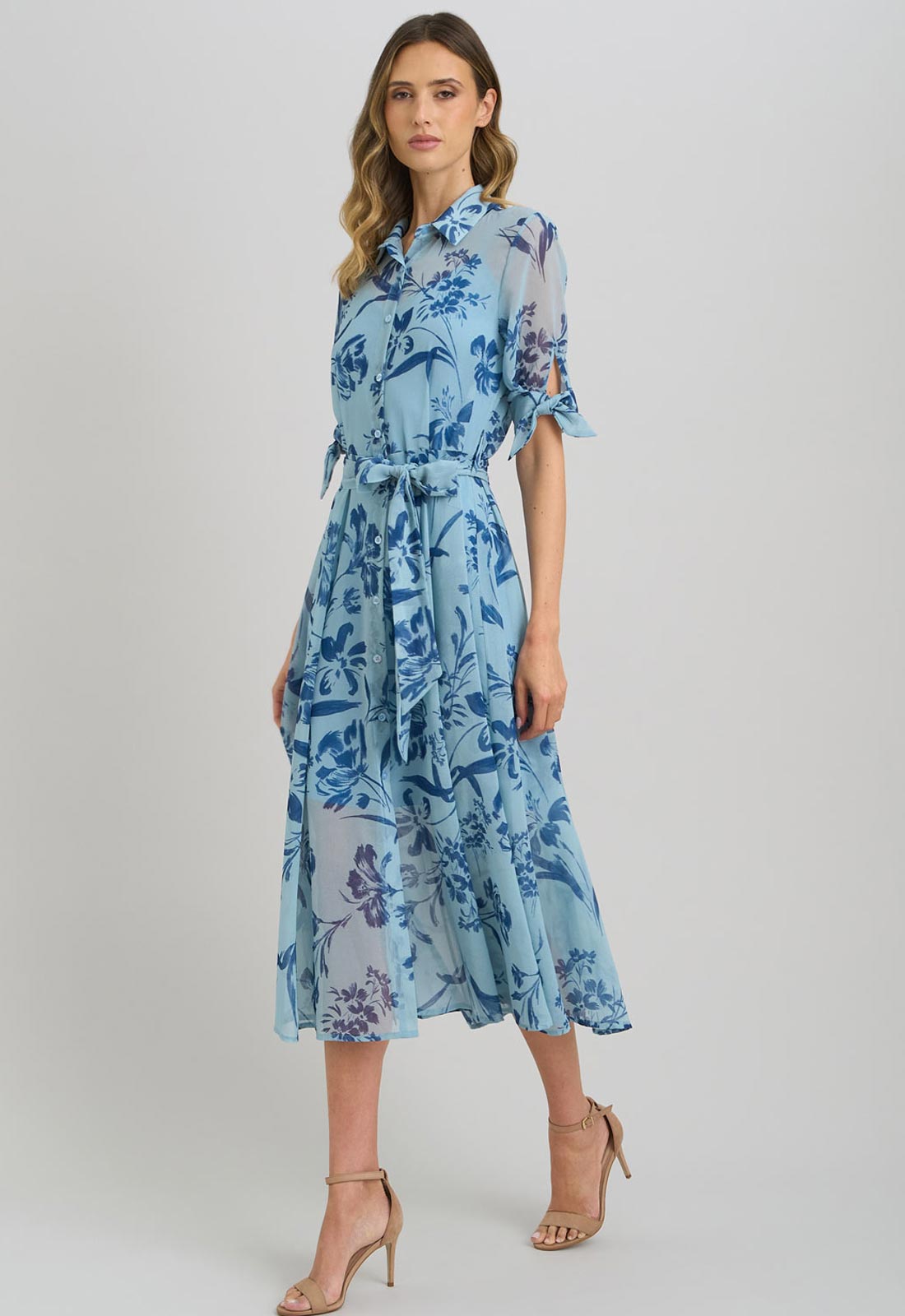 Woman wearing a blue floral dress on a white background