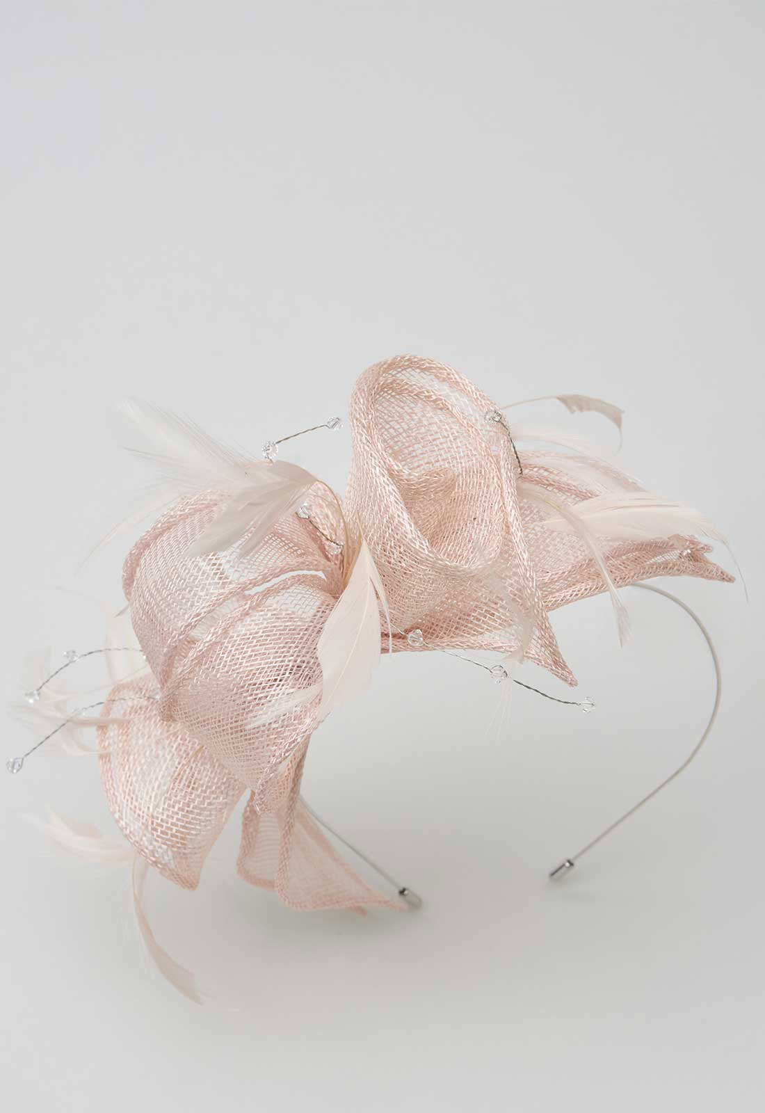 Pink decorative headband on a light gray background