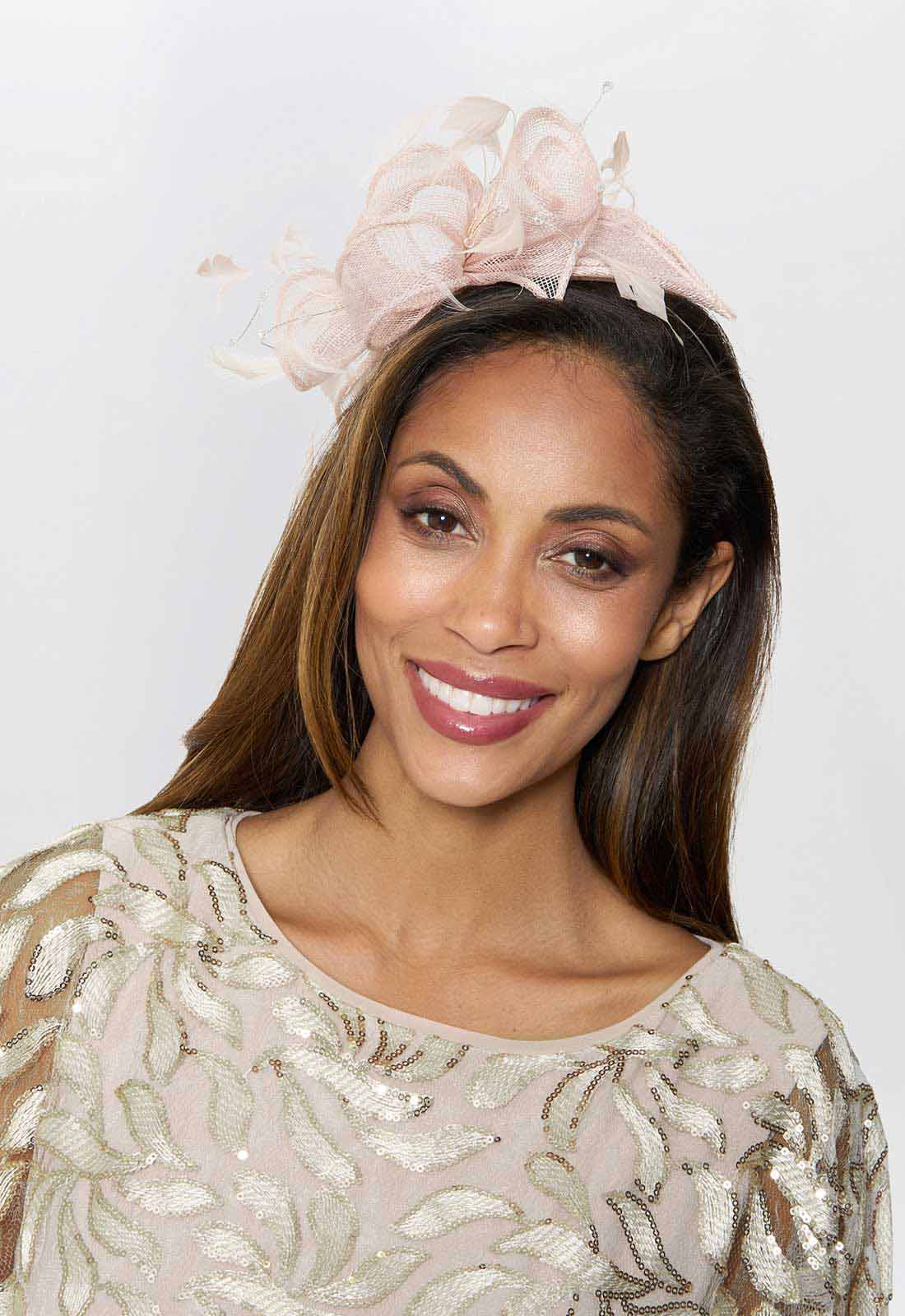 Woman wearing a decorative headpiece with a plain background