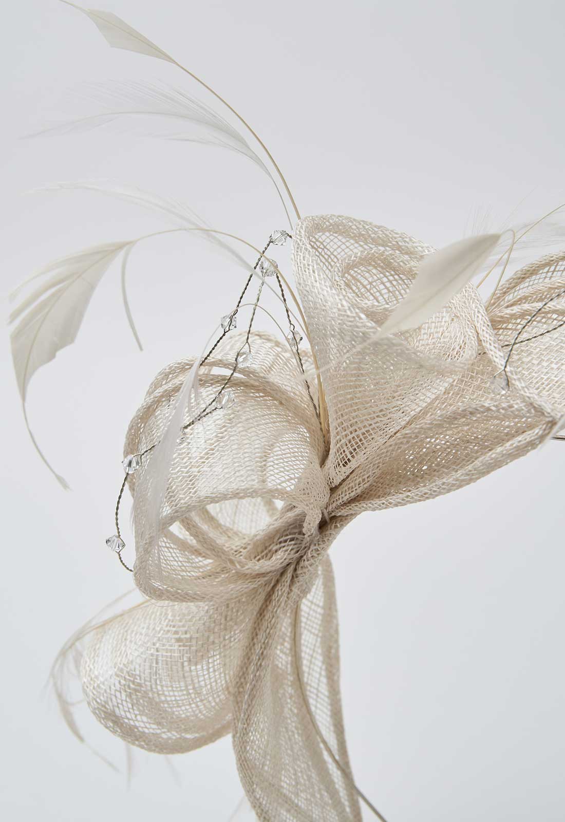 close up of the fascinator in beige
