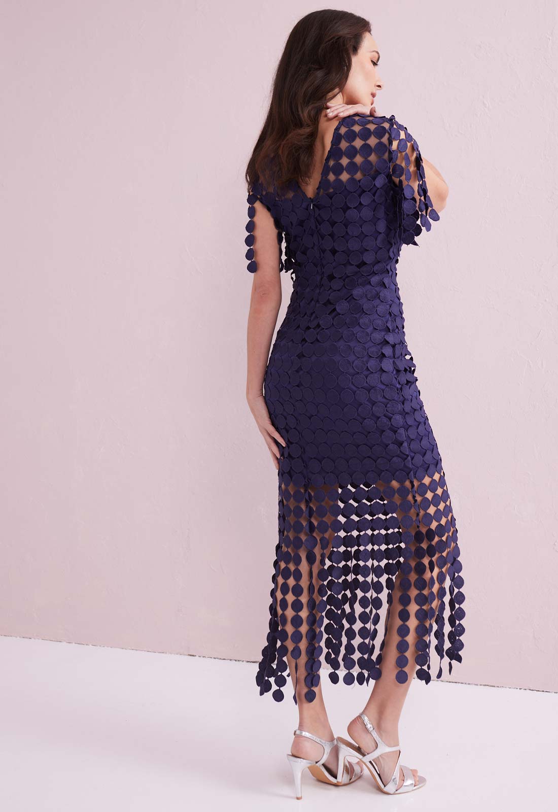 Navy blue dress with sheer overlay on a white background