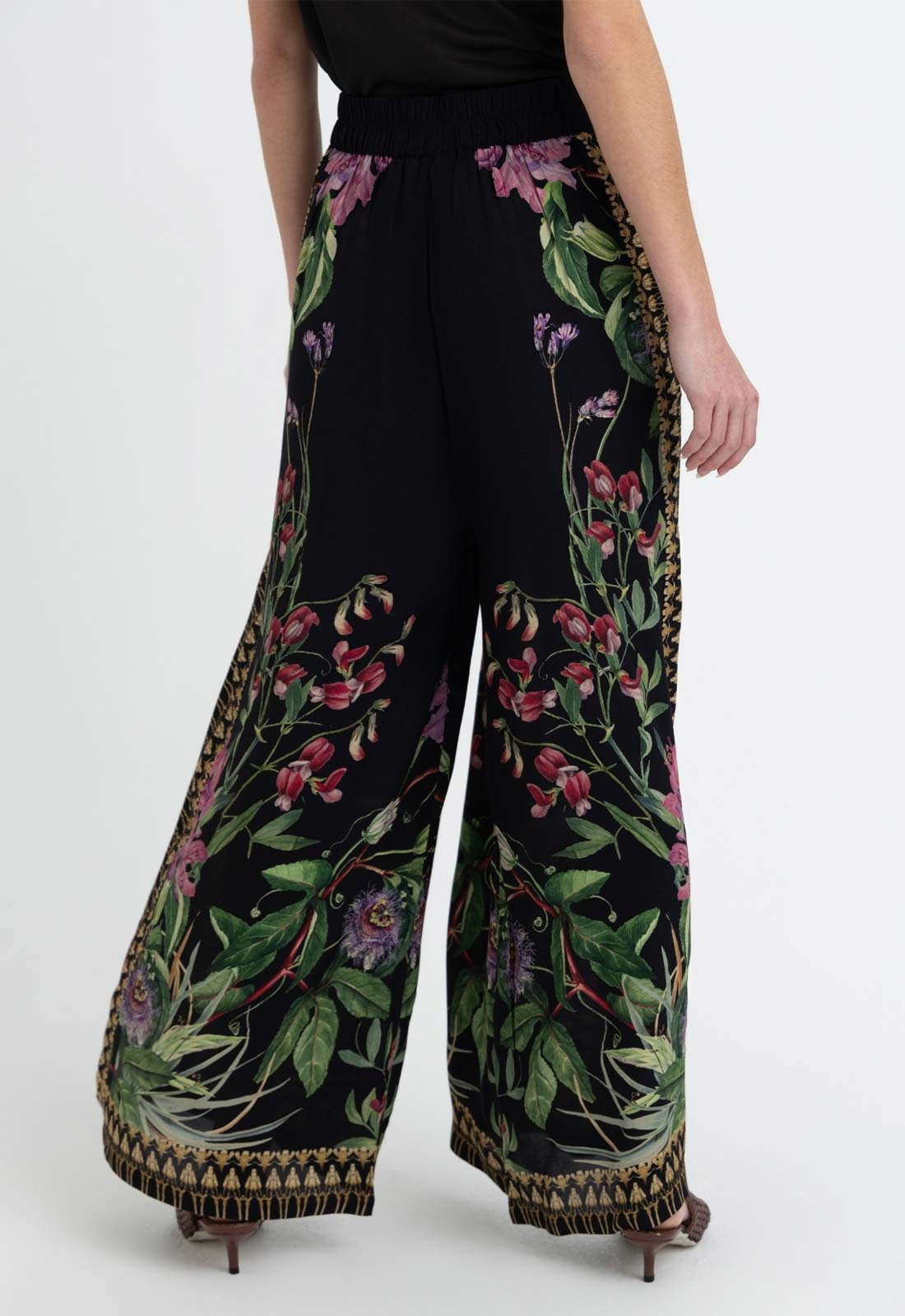 Black wide-leg pants with floral embroidery on a white background
