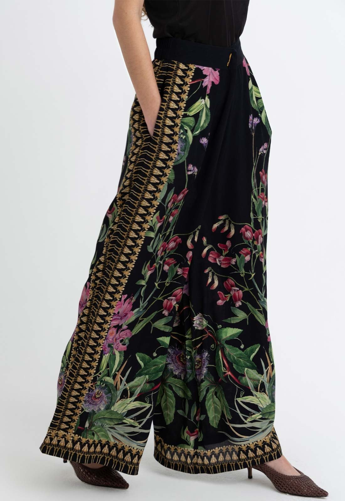 Black floral patterned pants with a white background