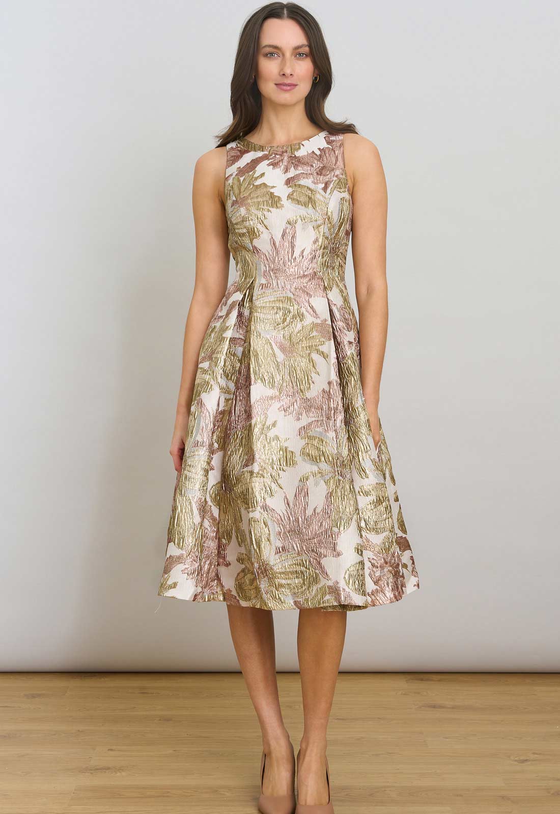 Woman wearing a floral dress against a plain background