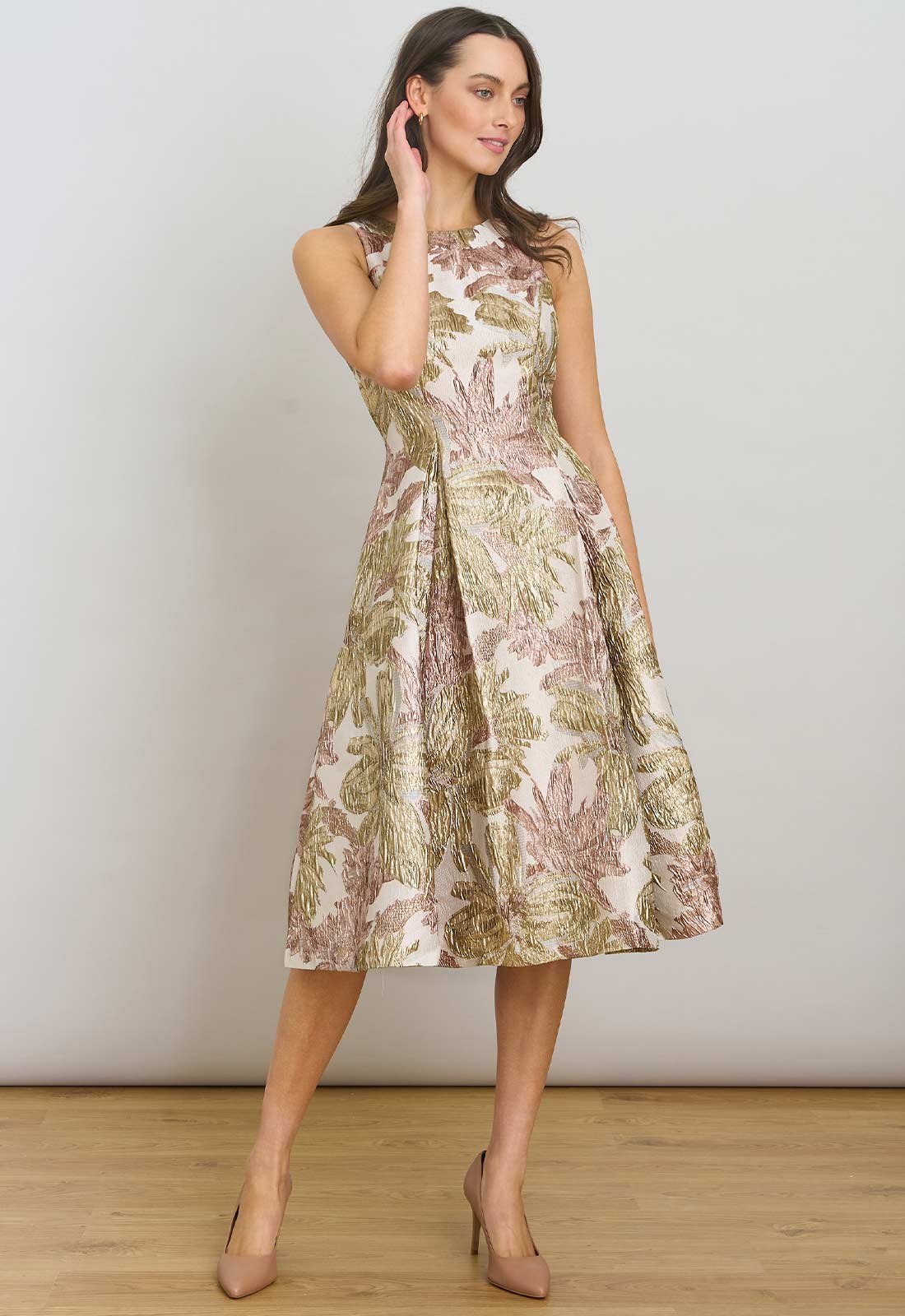Woman wearing a floral dress against a plain background