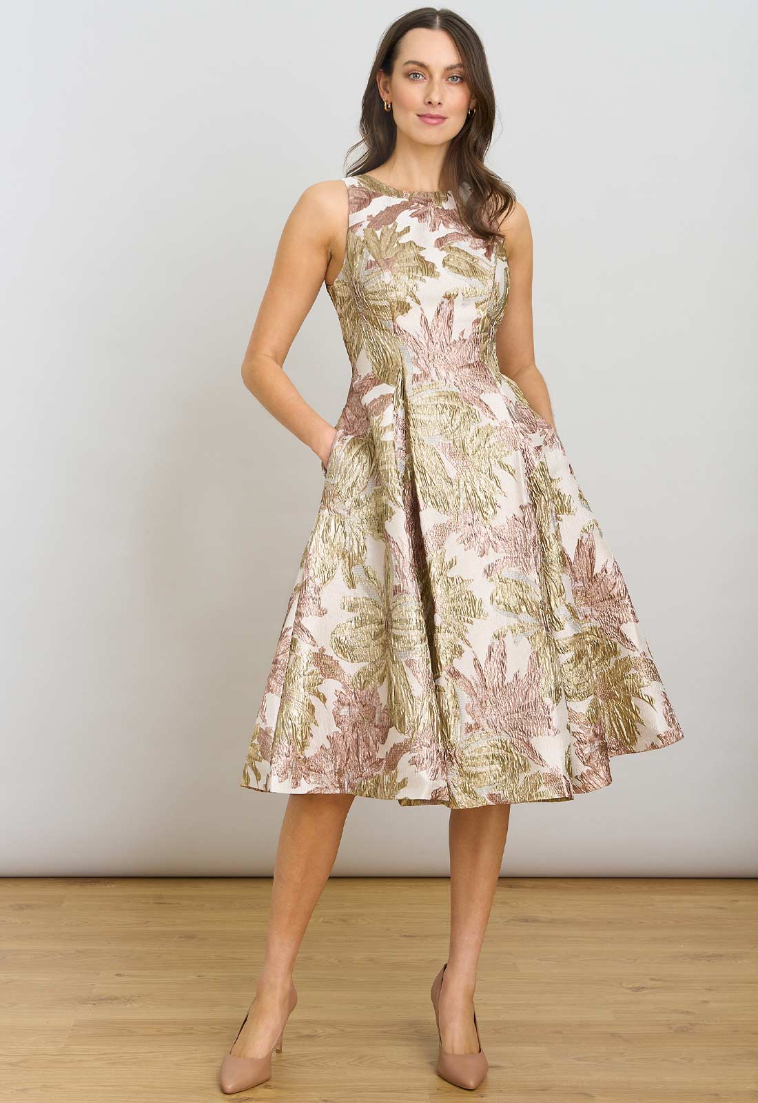 Woman wearing a floral patterned dress against a plain background