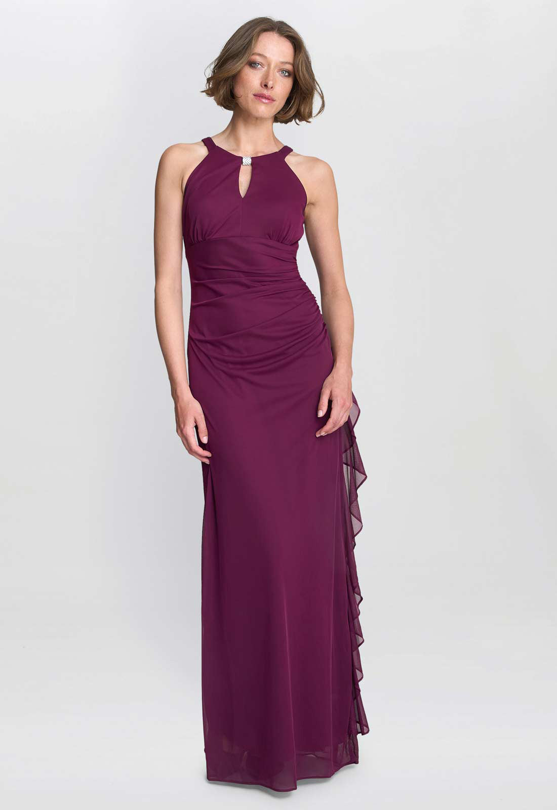 Woman wearing a purple evening gown on a white background