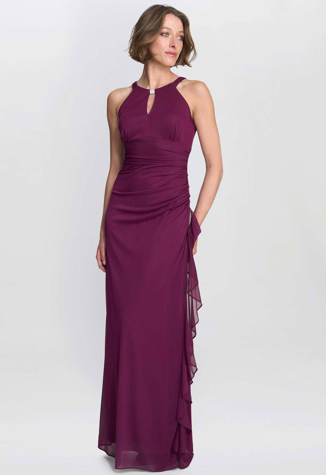 Woman wearing a purple evening gown on a white background
