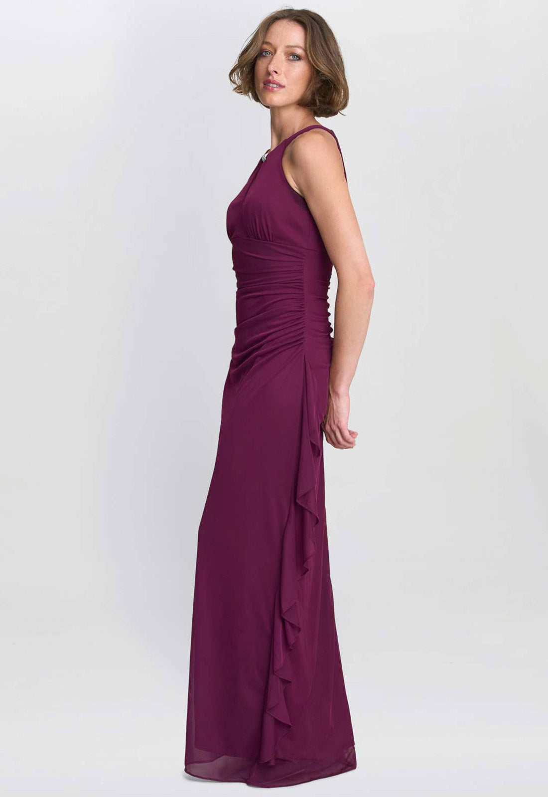 Woman wearing a purple evening gown on a white background
