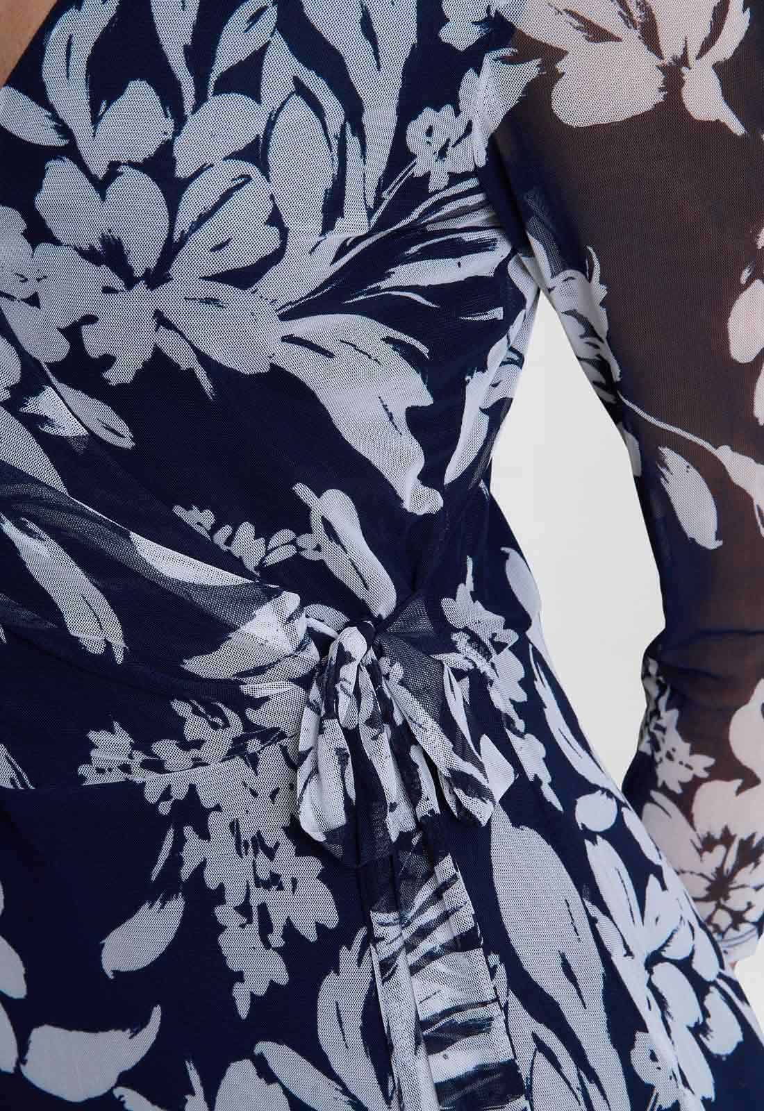 Navy blue fabric with white floral pattern on a brown background