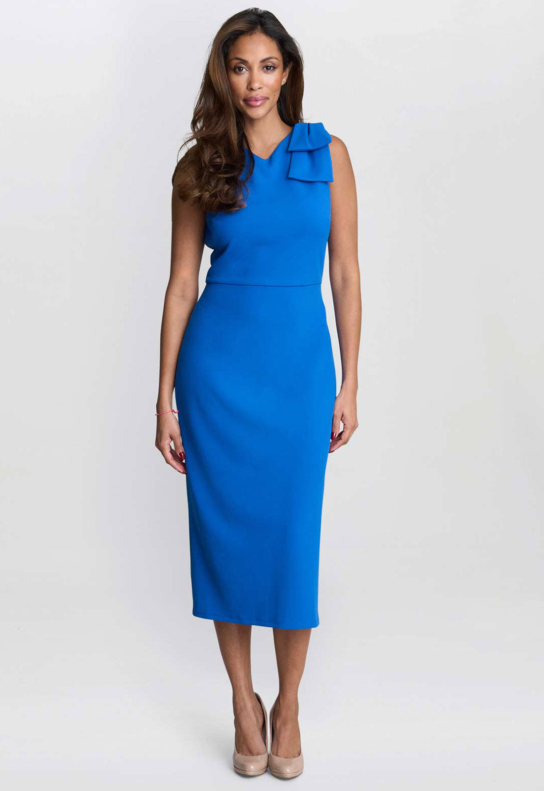 Woman wearing a blue dress with a ruffled neckline on a white background