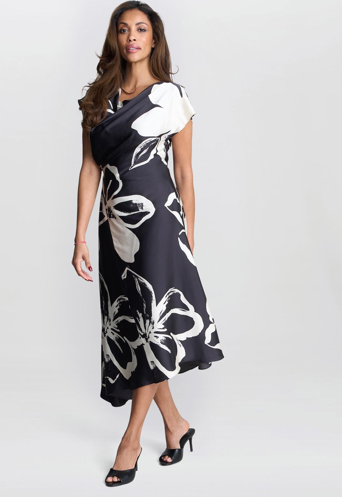 Woman wearing a black and white floral dress on a white background
