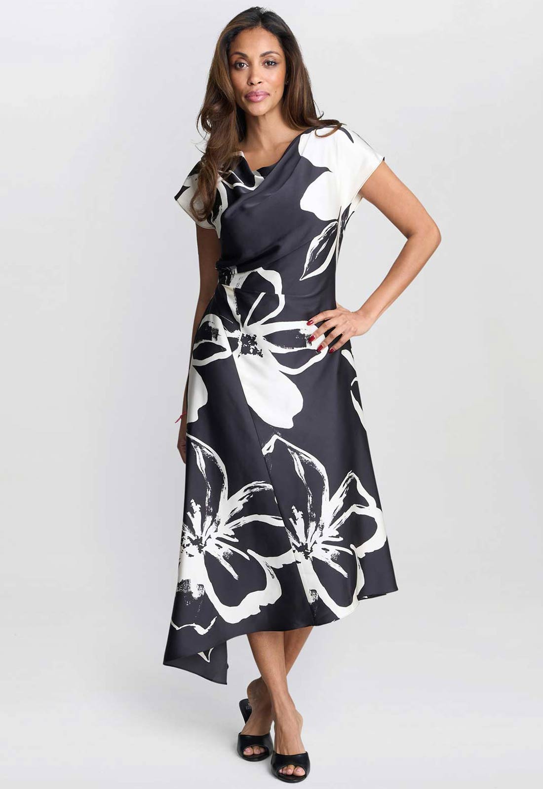 Woman wearing a black and white floral dress on a white background