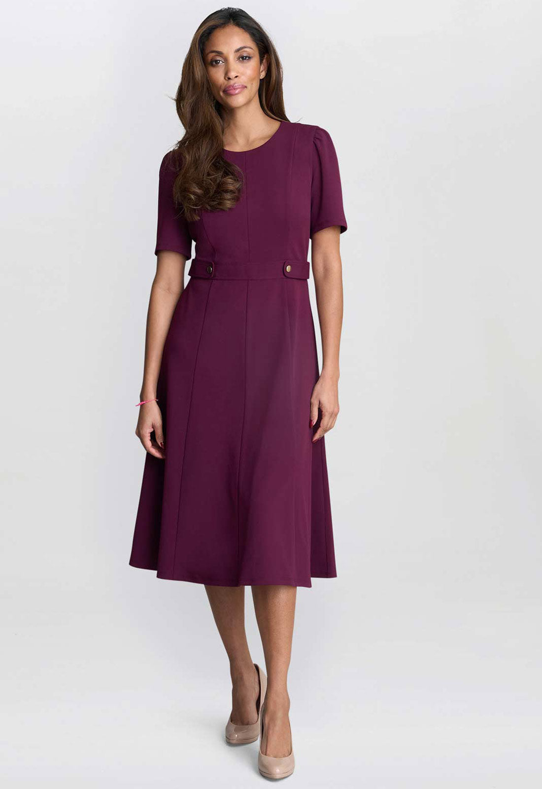 Woman wearing a purple dress on a white background