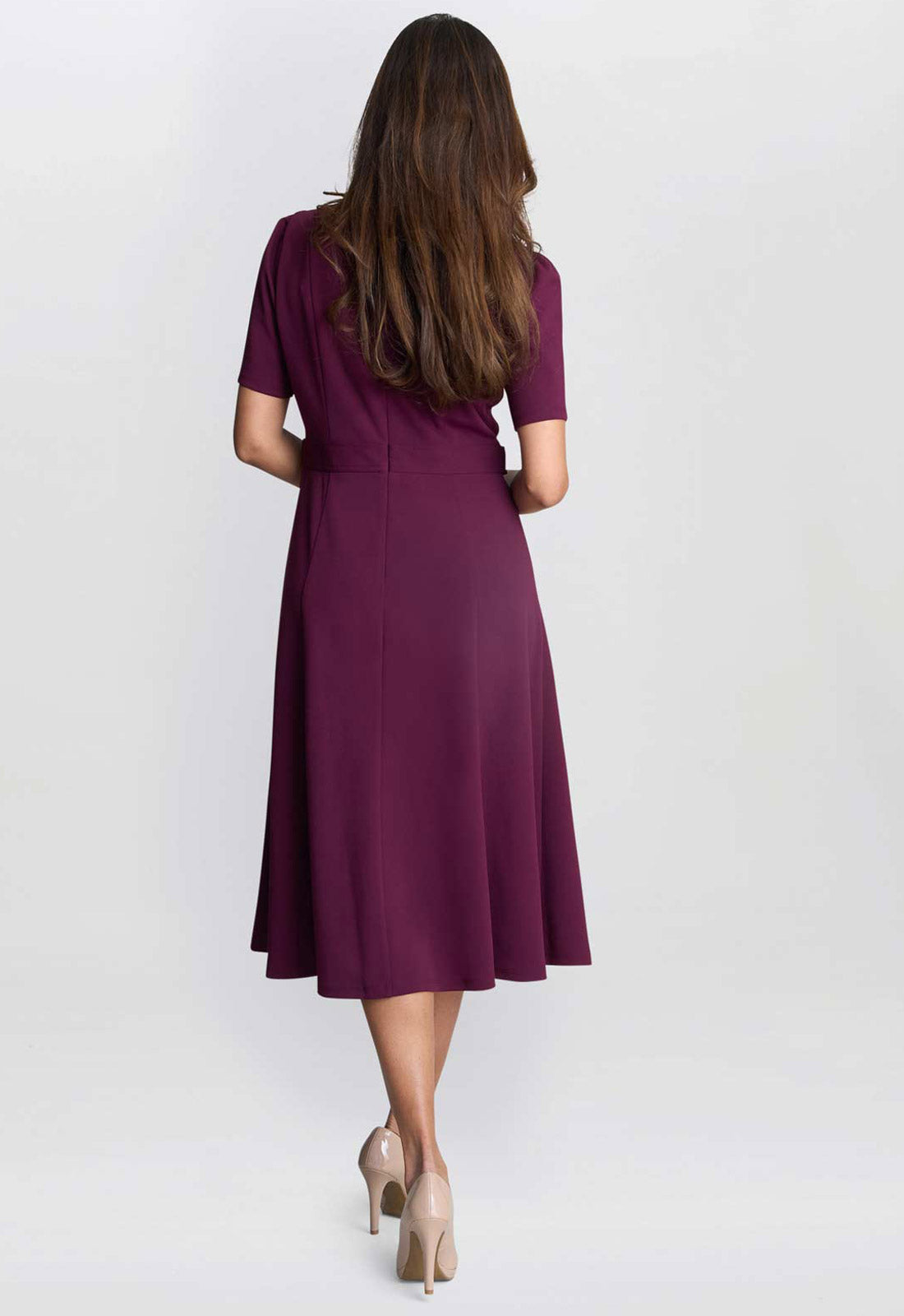 Woman wearing a purple dress on a white background
