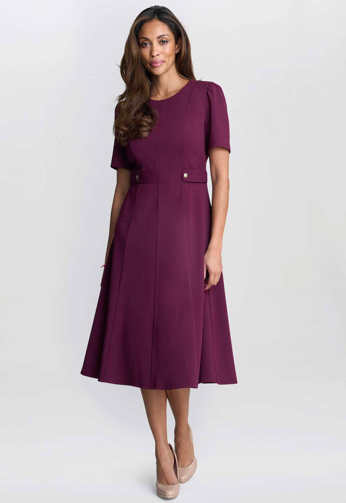 Woman wearing a purple dress on a white background
