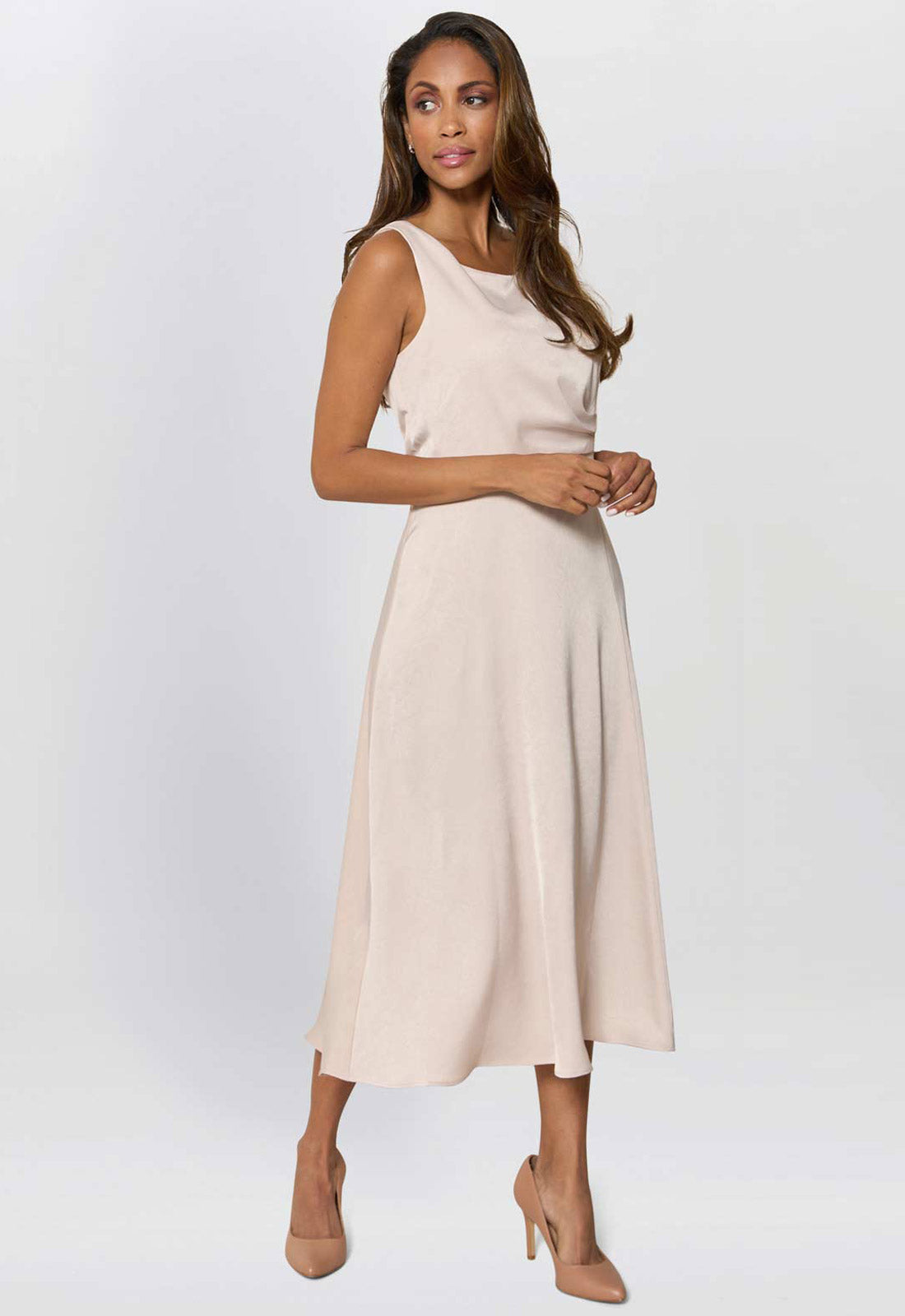 Woman wearing a beige dress on a white background