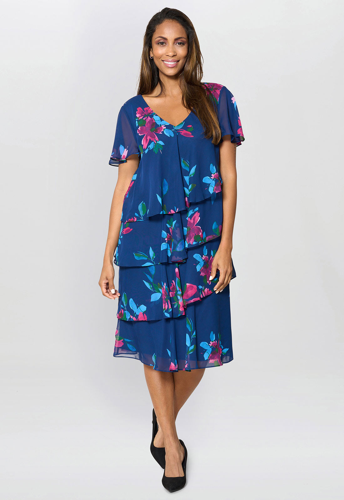 Woman wearing a blue floral dress on a white background
