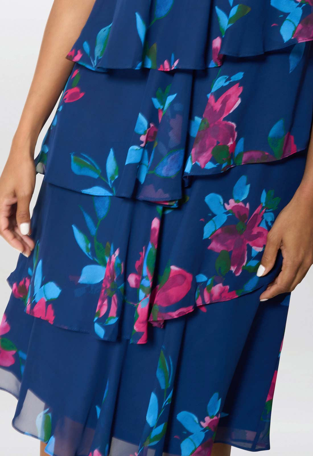 Blue floral dress with ruffled layers on a white background