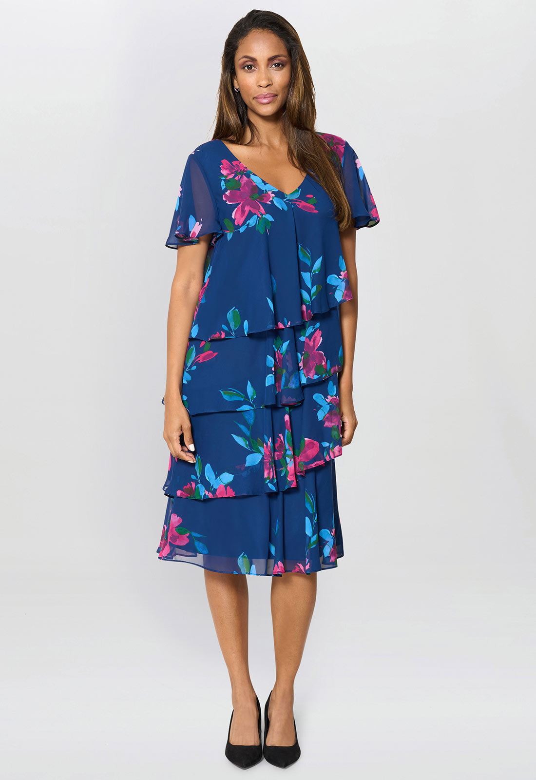 Woman wearing a blue floral dress on a white background