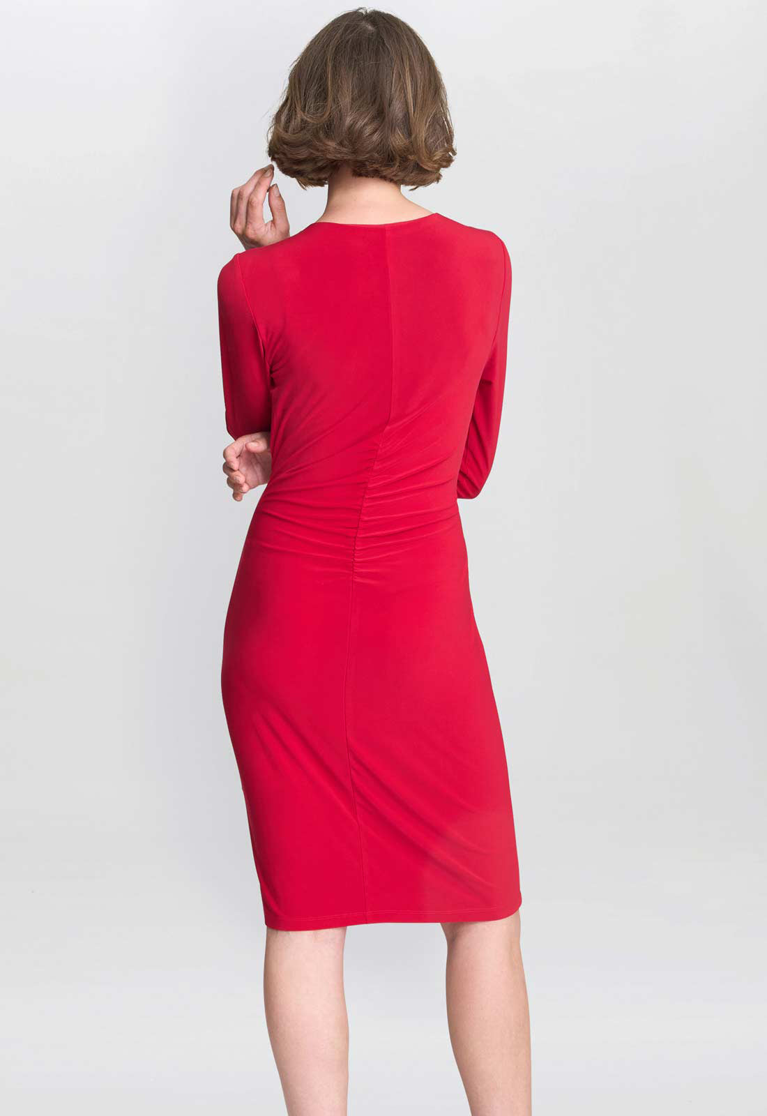 Red dress worn by a person on a white background