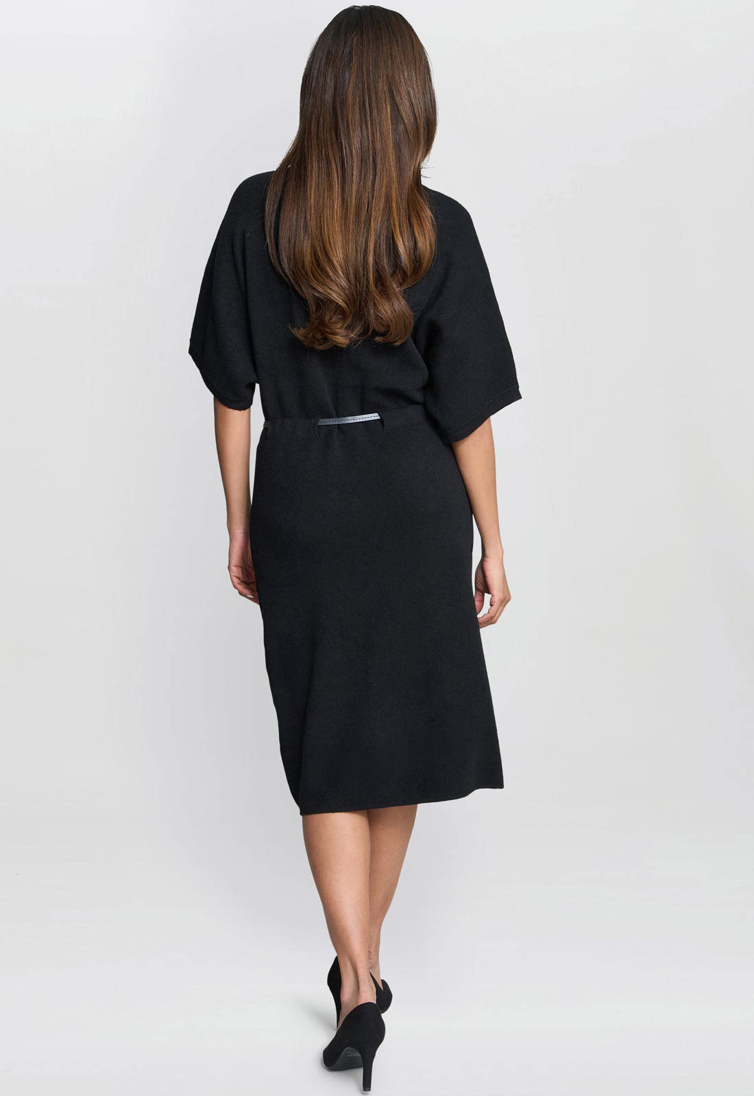 Woman wearing a black dress on a white background