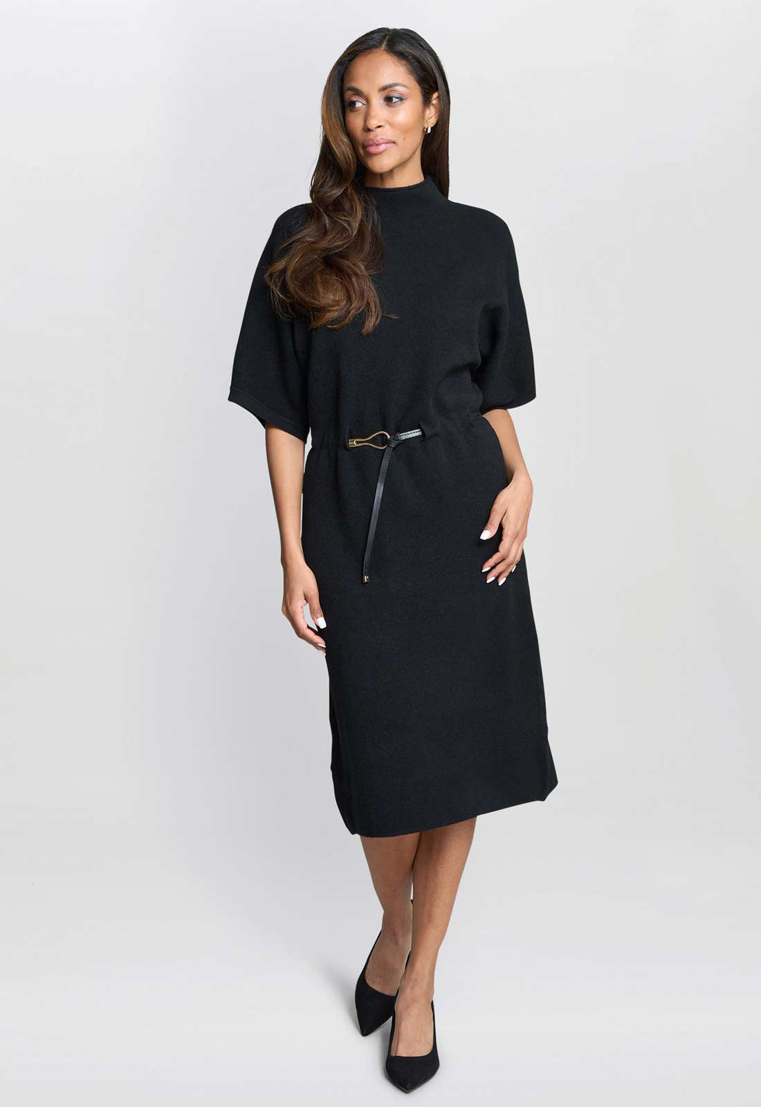 Woman wearing a black dress with a zipper detail on a white background