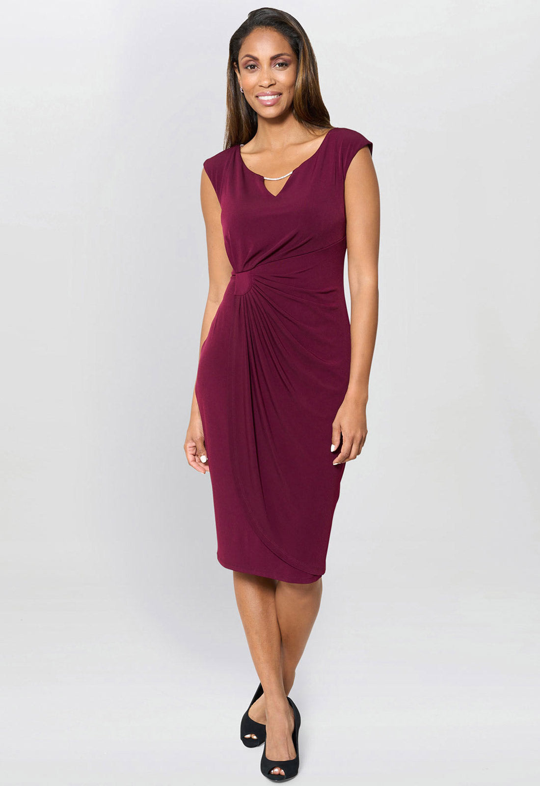 Woman wearing a burgundy dress on a white background