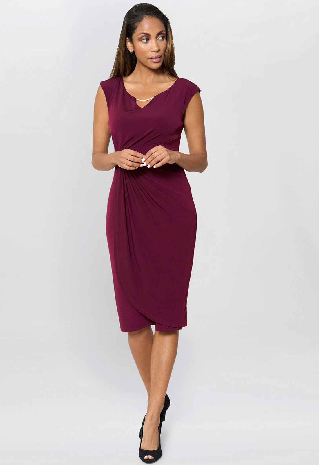 Woman wearing a burgundy dress on a white background