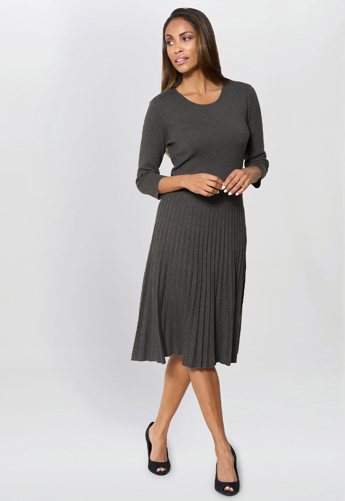 Woman wearing a gray dress on a white background