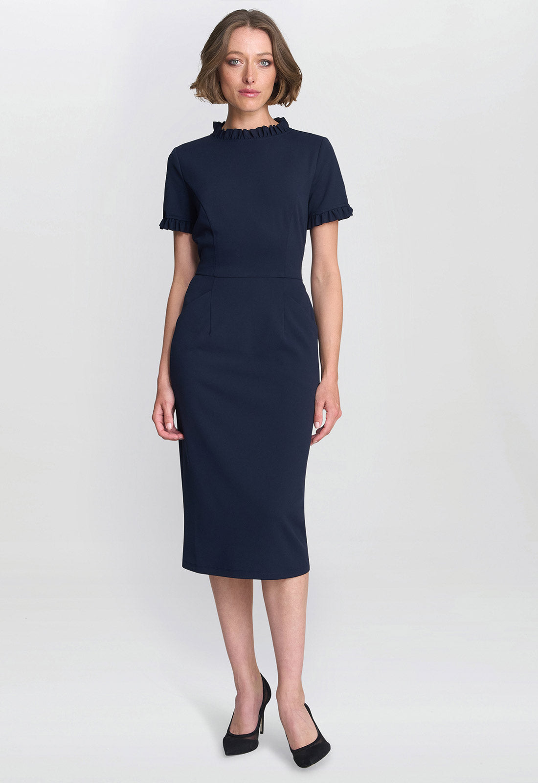 Woman wearing a navy blue dress on a white background