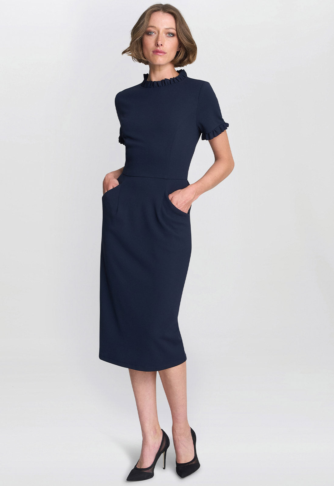 Woman wearing a navy blue dress on a white background