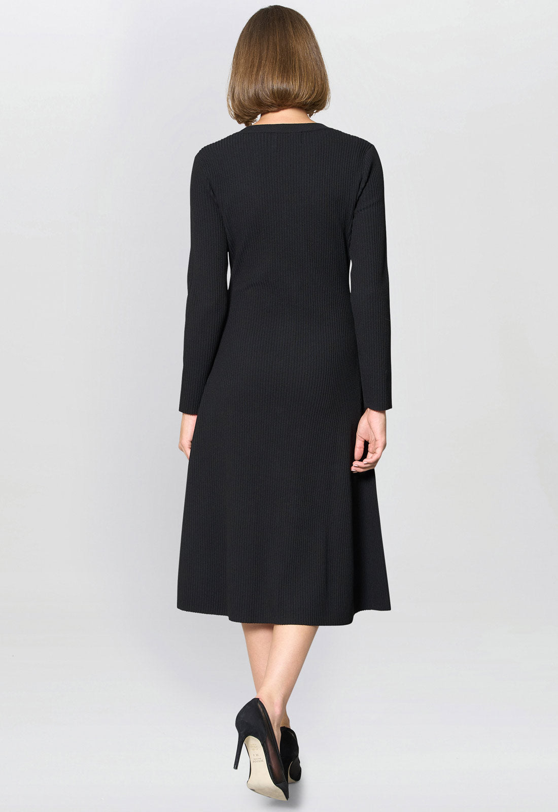 Woman wearing a black dress on a white background