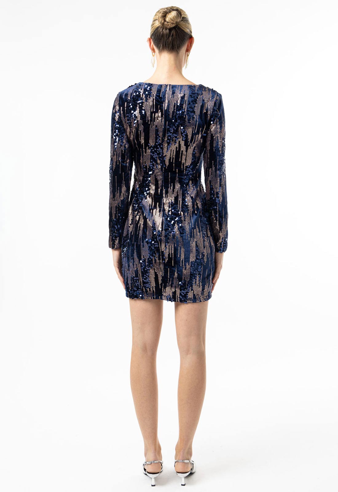 Woman wearing a patterned dress on a white background