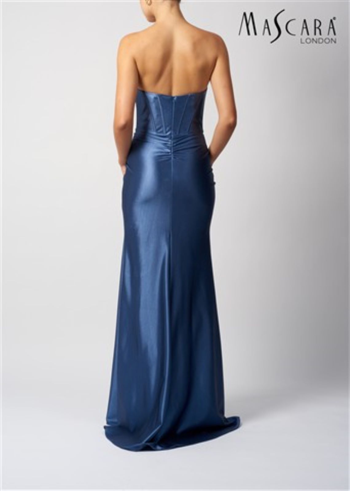 Woman wearing a strapless blue evening gown on a white background with 'Mascara London' branding.